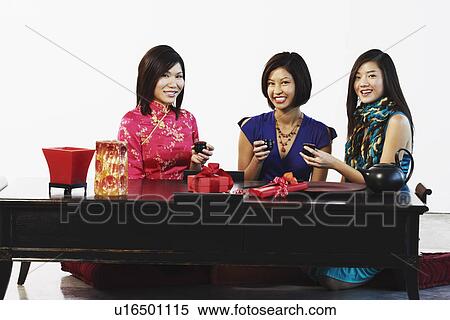 Portrait of three young women sitting together View Large Photo Image Stock Photography - Portrait of three young women sitting together. Fotosearch