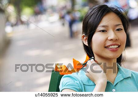 Stock Photography - Close-up of a young woman carrying a shopping bag. Fotosearch