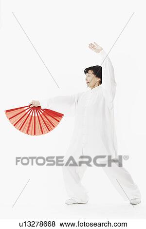Stock Photo - Mature woman dancing while holding a parasol. Fotosearch