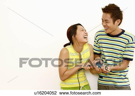 Close-up of a young couple holding a drill and laughing View Large Photo Image Stock Image - Close-up of a young couple holding a drill and laughing. Fotosearch