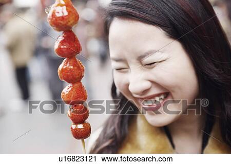 Close-up of a young woman smiling behind a stick of avocado's View Large Photo Image Stock Image - Close-up of a young woman smiling behind a stick of avocado's. Fotosearch