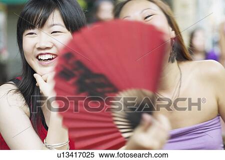 Stock Photography - Close-up of two young women smiling. Fotosearch