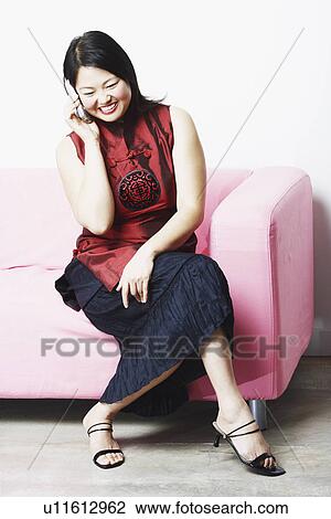 Stock Image - Mid adult woman talking on a mobile phone. Fotosearch