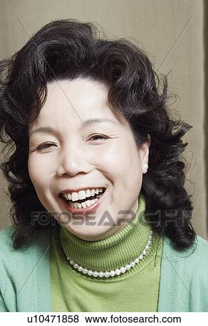 Stock Photo - Portrait of a businesswoman laughing. Fotosearch