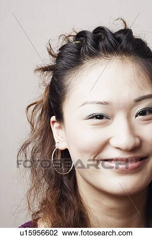 Stock Image - Portrait of a young woman smiling. Fotosearch
