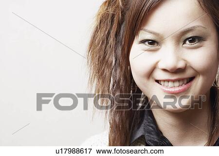Stock Photo - Portrait of a young woman smiling. Fotosearch