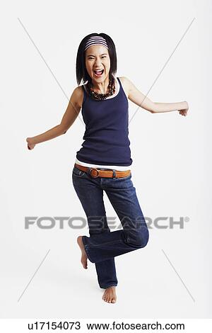 Portrait of a young woman standing on one leg View Large Photo Image Stock Image - Portrait of a young woman standing on one leg. Fotosearch