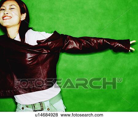 Stock Photo - Portrait of a young woman stretching her arms. Fotosearch