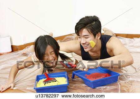 Young couple lying together on the floor and smiling View Large Photo Image Stock Photo - Young couple lying together on the floor and smiling. Fotosearch