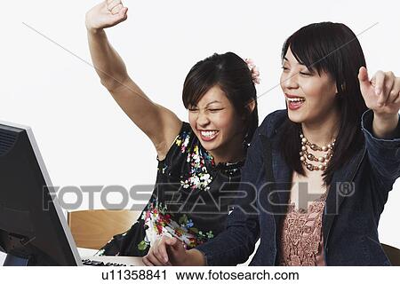 Close-up of two businesswomen smiling with their hands raised View Large Photo Image Stock Image - Close-up of two businesswomen smiling with their hands raised. Fotosearch