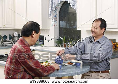 Stock Photo - Close-up of two senior men at the table. Fotosearch