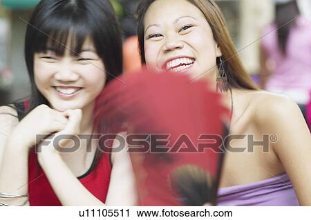 Close-up of two young women smiling View Large Photo Image Stock Image - Close-up of two young women smiling. Fotosearch