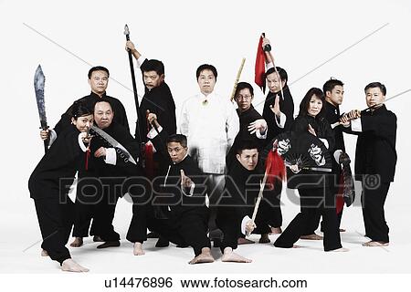 Stock Photograph - Portrait of a group of people gesturing with weapons. Fotosearch
