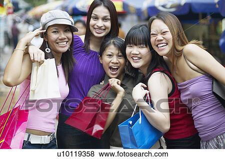 Stock Photo - Portrait of a group of young women smiling. Fotosearch