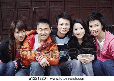 Portrait of a teenage boy smiling with two young men and two young women View Large Photo Image Picture - Portrait of a teenage boy smiling with two young men and two young women. Fotosearch