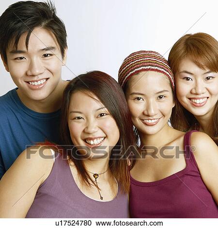 Stock Image - Portrait of two young men with three young women posing and smiling. Fotosearch