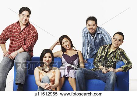 Stock Photography - Portrait of two young women and three young men smiling. Fotosearch