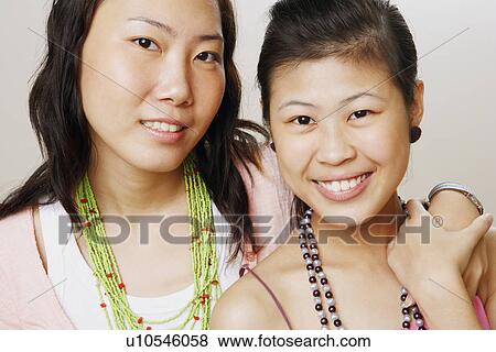 Portrait of two young women smiling View Large Photo Image Stock Photo - Portrait of two young women smiling. Fotosearch