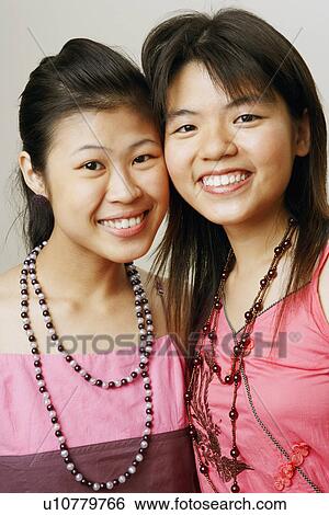 Portrait of two young women smiling View Large Photo Image Stock Photograph - Portrait of two young women smiling. Fotosearch