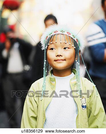 Stock Photo - Close-up of a girl wearing an ornate headdress. Fotosearch