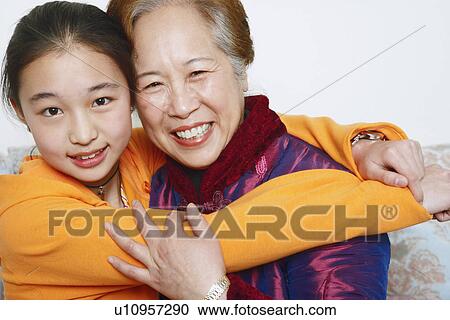 Portrait of a daughter hugging her mother View Large Photo Image Stock Image - Portrait of a daughter hugging her mother. Fotosearch