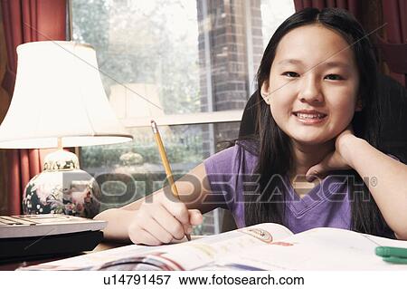 Stock Photo - Portrait of a girl holding a pencil. Fotosearch