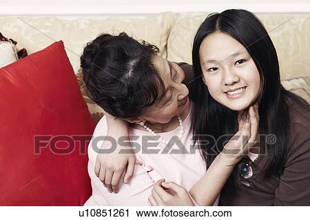 Portrait of a girl hugging her grandmother View Large Photo Image Stock Image - Portrait of a girl hugging her grandmother. Fotosearch
