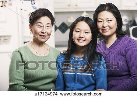Portrait of a girl smiling with her mother and grandmother View Large Photo Image Picture - Portrait of a girl smiling with her mother and grandmother. Fotosearch