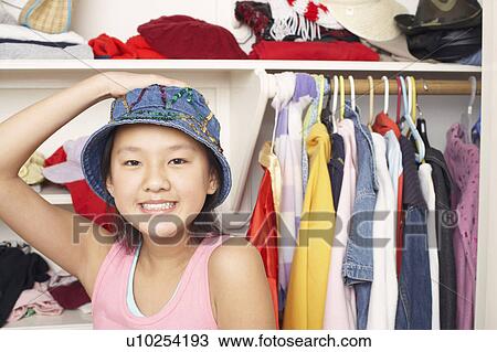 Stock Image - Portrait of a girl wearing a hat. Fotosearch