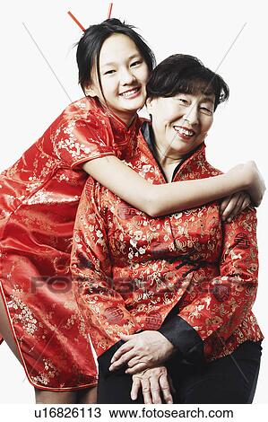 Stock Image - Portrait of a granddaughter hugging her grandmother. Fotosearch