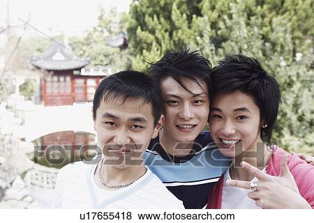 Stock Photo - Portrait of a teenage boy and two young men. Fotosearch