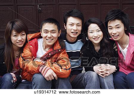 Portrait of a teenage boy smiling with two young men and two young women View Large Photo Image Stock Image - Portrait of a teenage boy smiling with two young men and two young women. Fotosearch