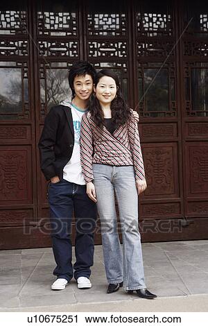 Portrait of a teenage boy standing with a young woman View Large Photo Image Stock Image - Portrait of a teenage boy standing with a young woman. Fotosearch