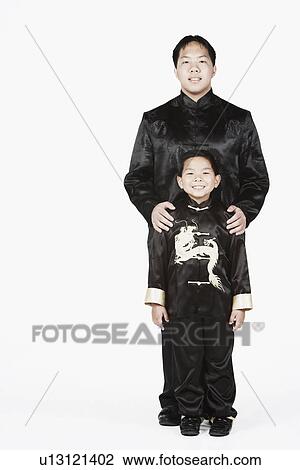 Portrait of a teenage boy standing with his brother View Large Photo Image Stock Image - Portrait of a teenage boy standing with his brother. Fotosearch