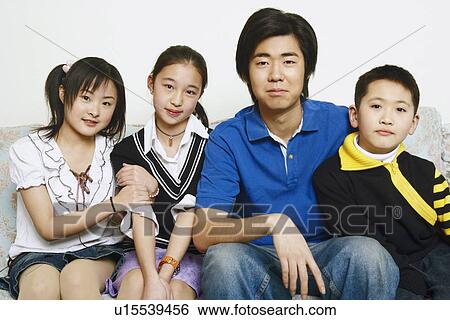 Stock Photograph - Portrait of brothers and sisters sitting together. Fotosearch