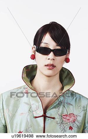 Stock Photo - Close-up of a young woman wearing sunglasses. Fotosearch