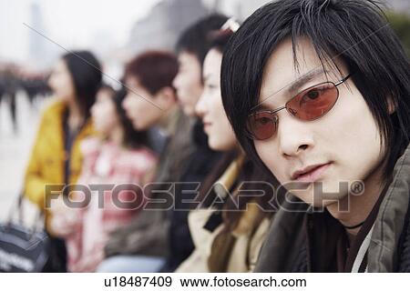 Portrait of a young man wearing sunglasses View Large Photo Image Stock Photo - Portrait of a young man wearing sunglasses. Fotosearch