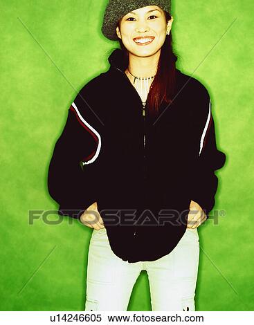 Portrait of a young woman smiling with her hands in her pockets View Large Photo Image Stock Photography - Portrait of a young woman smiling with her hands in her pockets. Fotosearch