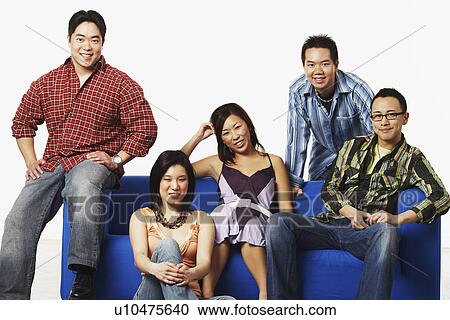 Portrait of two young women and three young men smiling View Large Photo Image Stock Image - Portrait of two young women and three young men smiling. Fotosearch
