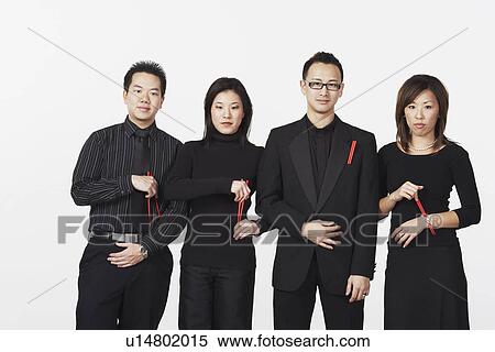 Two young men and two young women standing holding chopsticks View Large Photo Image Stock Photography - Two young men and two young women standing holding chopsticks. Fotosearch
