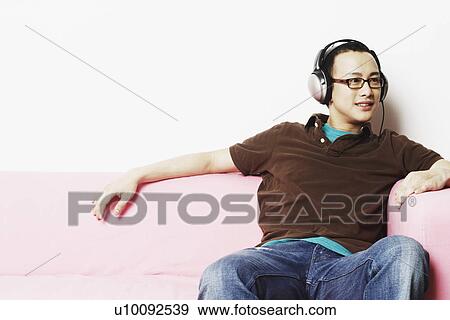 Stock Photo - Young man wearing headphones. Fotosearch
