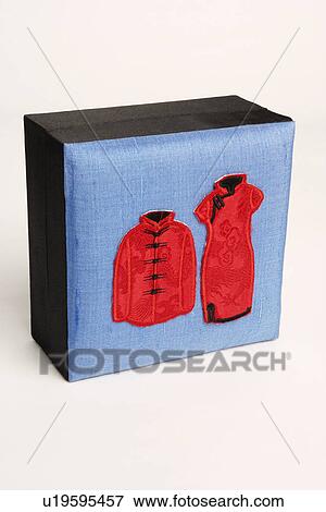 Stock Photo - Close-up of traditional Chinese outfits embroidered on a box. Fotosearch