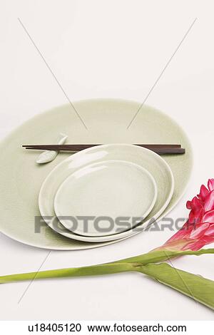 High angle view of chopsticks and plates with a flower View Large Photo Image Stock Image - High angle view of chopsticks and plates with a flower. Fotosearch