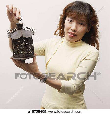 Stock Photography - Portrait of a mature woman holding a lantern. Fotosearch