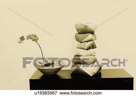 Stock Photo - Stack of cushions on a cabinet. Fotosearch