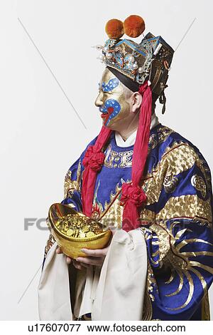 Close-up of a male Chinese opera performer holding a bowl full of gold coins View Large Photo Image Stock Photo - Close-up of a male Chinese opera performer holding a bowl full of gold coins. Fotosearch