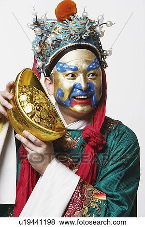 Close-up of a male Chinese opera performer holding a bowl full of gold coins View Large Photo Image Stock Photo - Close-up of a male Chinese opera performer holding a bowl full of gold coins. Fotosearch