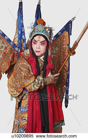 Stock Photography - Close-up of a male Chinese opera performer holding a weapon. Fotosearch