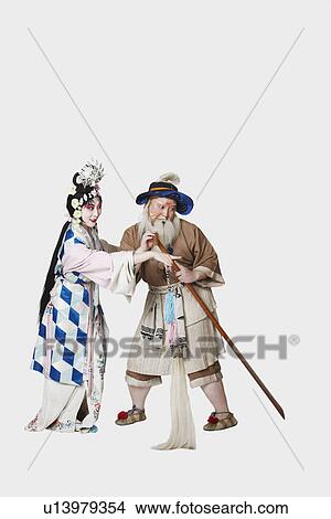 Mid adult man and a mature woman wearing traditional clothing View Large Photo Image Picture - Mid adult man and a mature woman wearing traditional clothing. Fotosearch