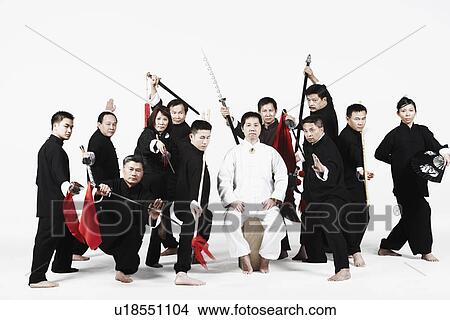 Picture - Portrait of a group of people gesturing with weapons. Fotosearch